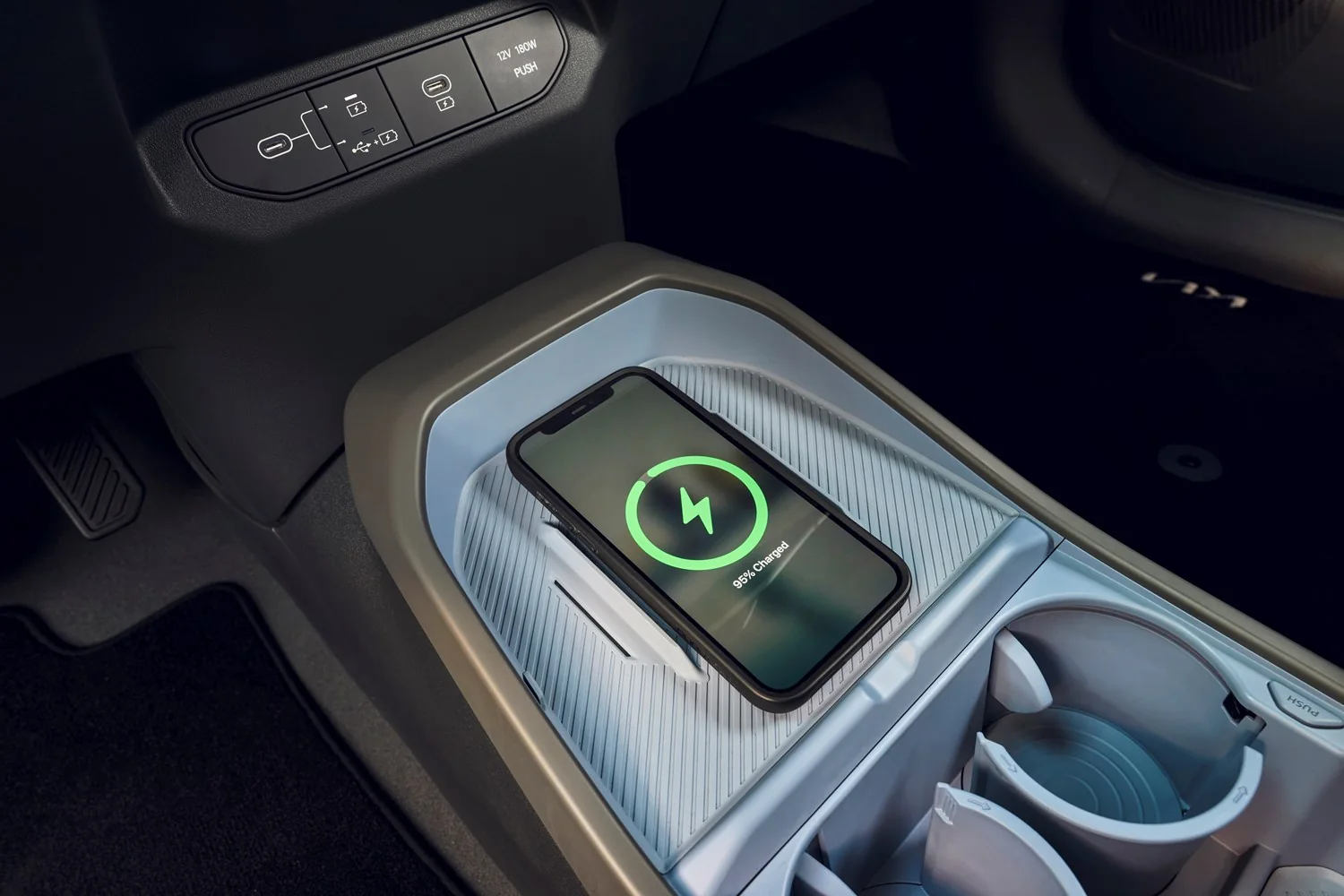 Phone on the Kia EV3 wireless charging pad